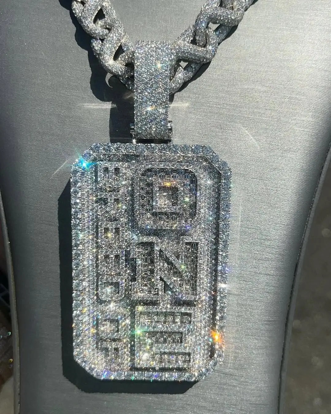 Vertical close view of the diamond Breed of One pendant and its bail