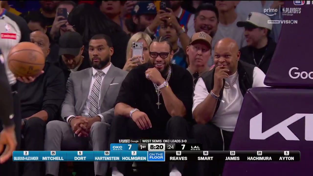 Full NBA on Prime courtside view of Dillon Brooks with diamond grill, layered chains, cross pendant, watch, ring and bracelet visible