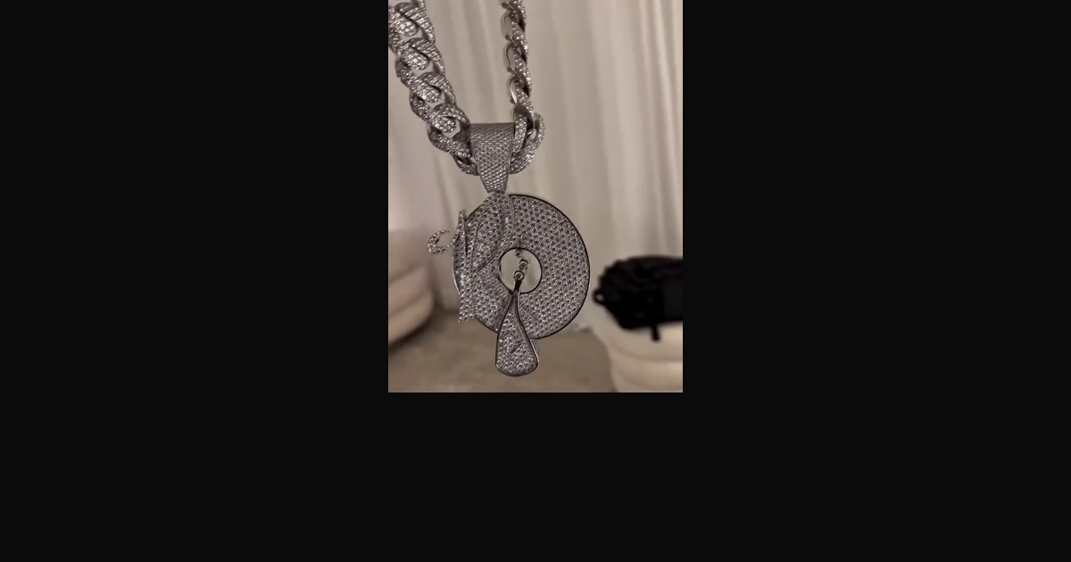 Roc-A-Fella pendant with a triangular bail and stone-set links, shown alone in a frame from video by Lenny S. (@kodaklens).