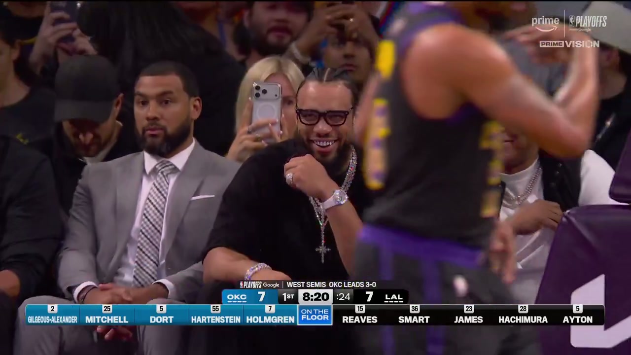 Wide NBA on Prime broadcast frame of Dillon Brooks seated courtside in black with his jewelry visible
