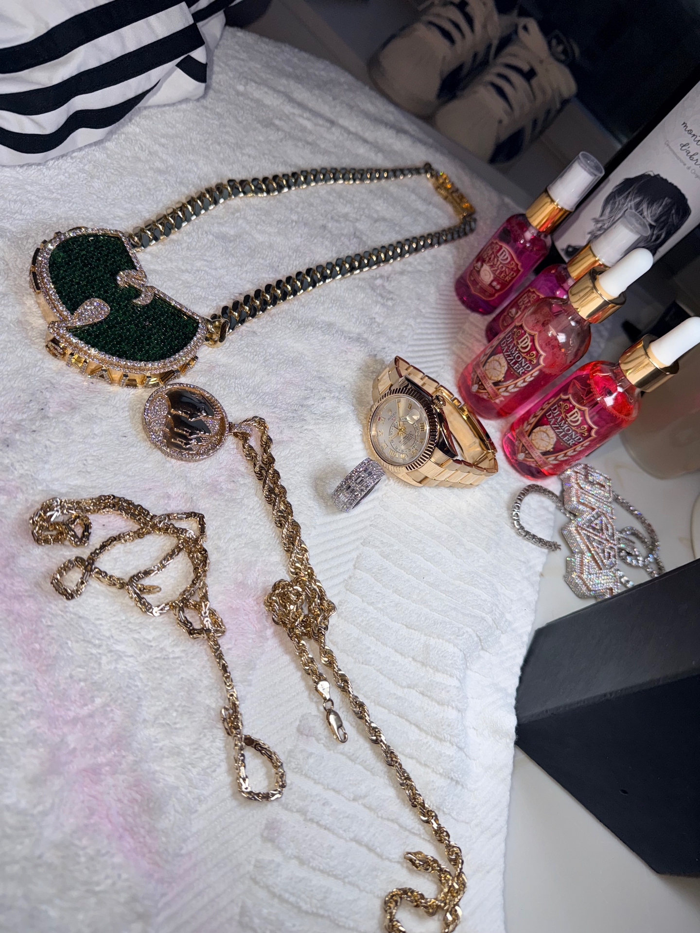 Wu-Tang Clan jewelry alongside Diamond Dazzler cleaning solution bottles