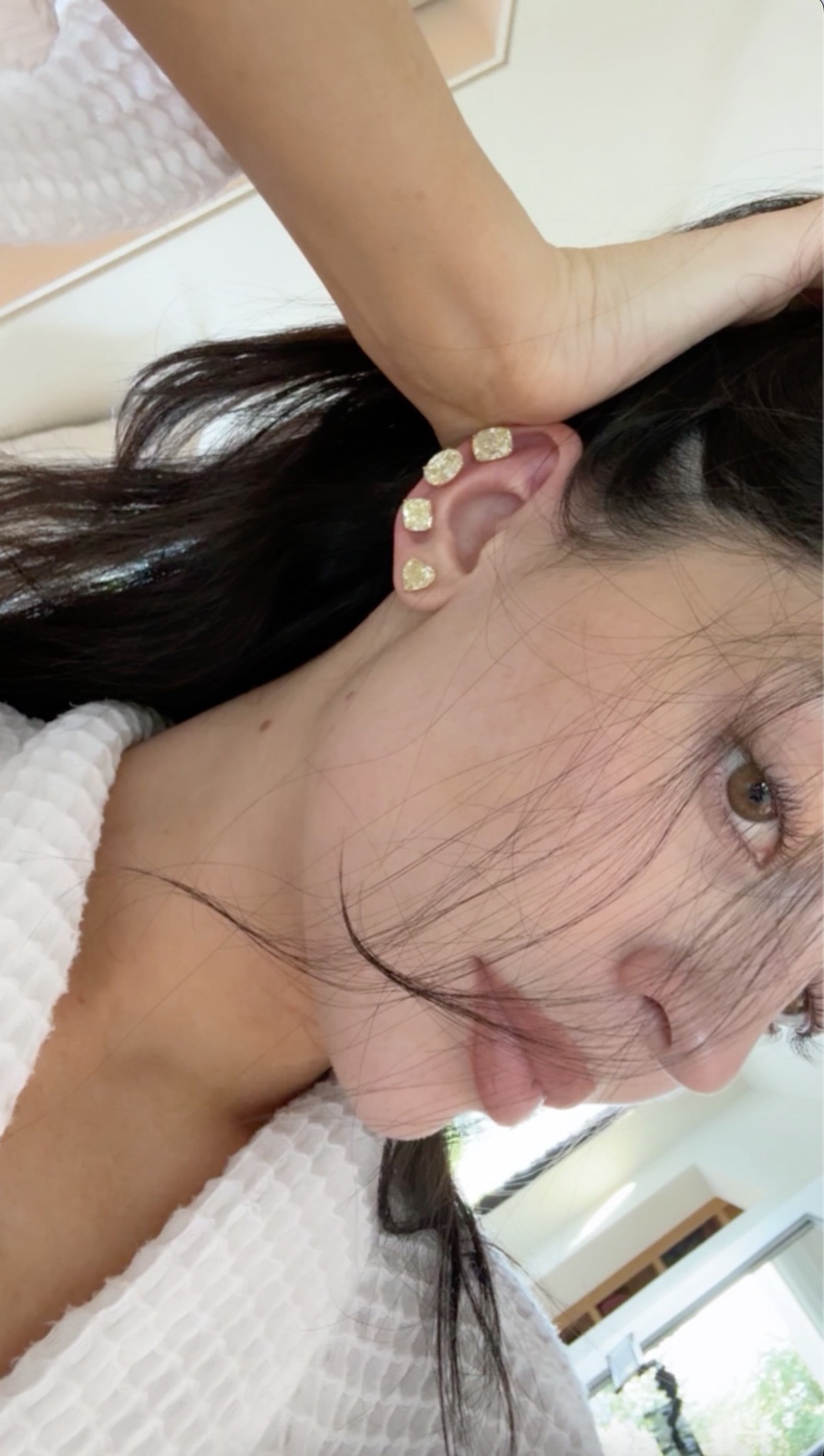 She shared a trio of images on social media wearing four climbing yellow diamond stud earrings in a variety of shapes. Photo: Kylie Jenner/Instagram.