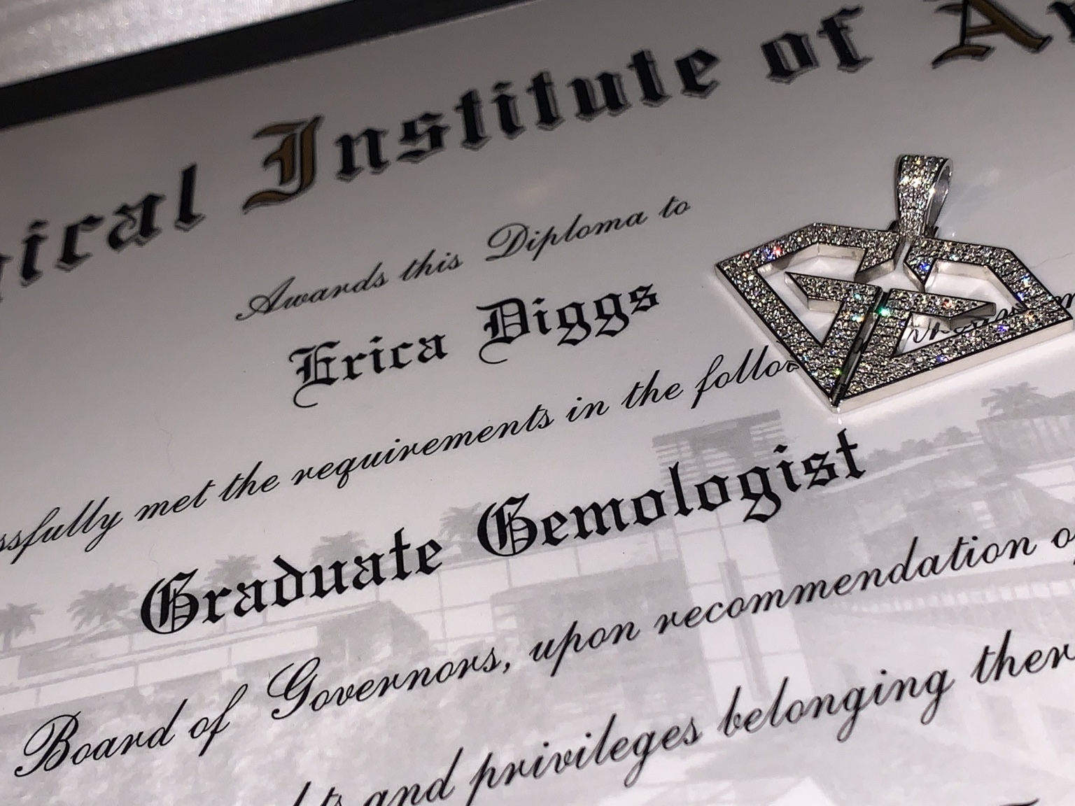 Erica Diggs' GIA Graduate Gemologist diploma and diamond pendant