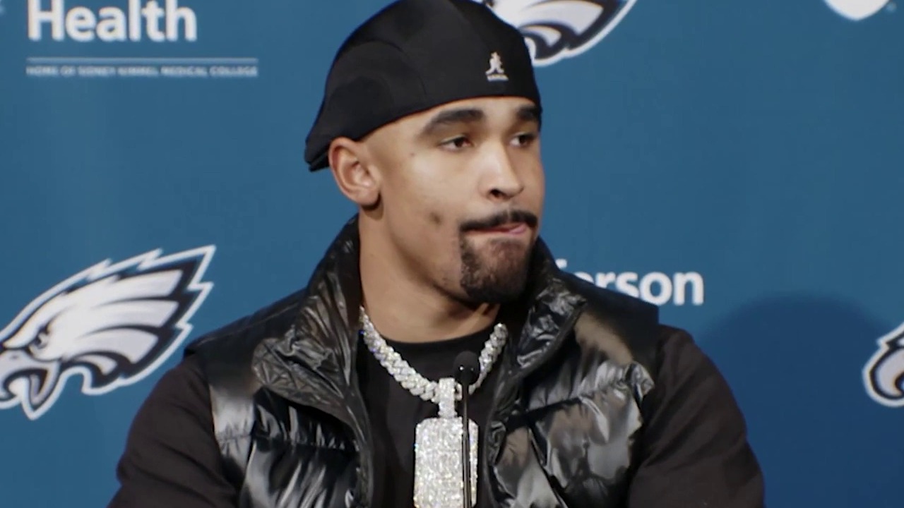 Jalen Hurts seated at the Eagles postgame podium wearing the Breed of One pendant