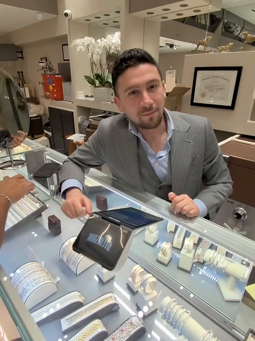 Avraham speaking at the jewelry counter inside Mazalito Jewelry