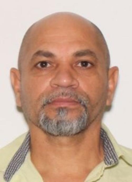 Official FBI wanted photograph of Alberto Perez-Elias taken in 2018, showing a bald man with a grey goatee in a light green collared shirt.