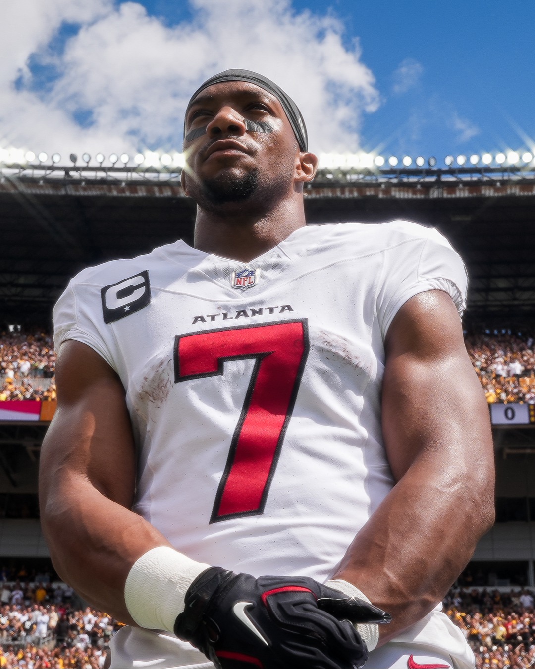 Atlanta Falcons running back Bijan Robinson celebrates with the football during a game.