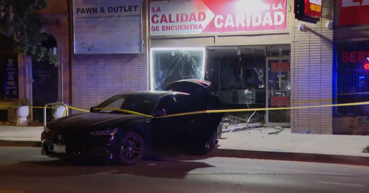 A car and damaged Chicago storefront behind police tape in the supplied CBS Chicago report image.