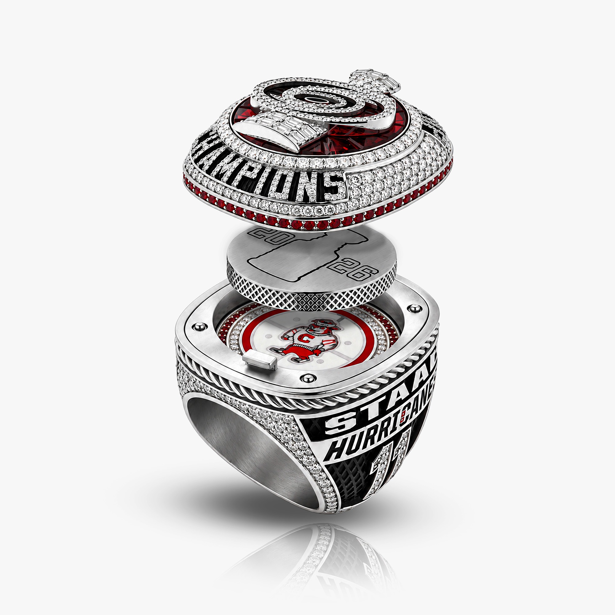 The championship ring shown with its removable puck pendant lifted above the shank.