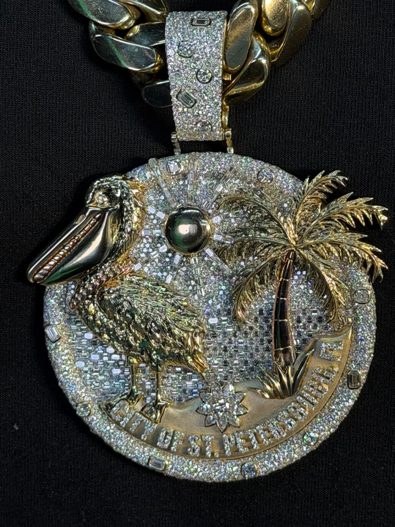 Nino Breeze's custom City of St. Petersburg pendant: pave and baguette diamonds with yellow gold pelican and palm