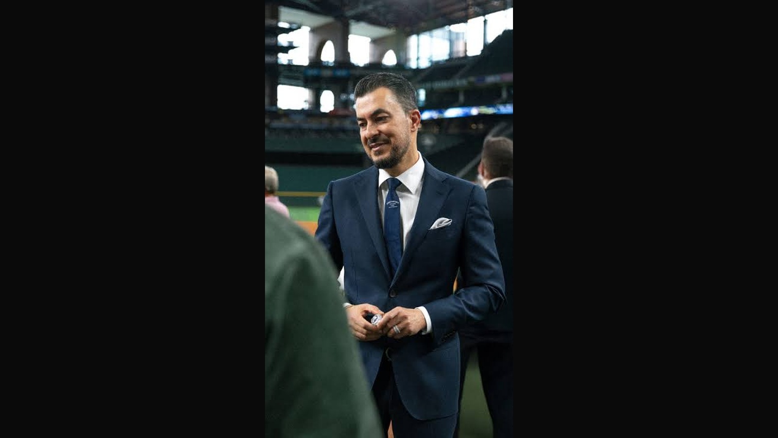 Jason Arasheben, founder of Jason of Beverly Hills, in a dark suit with his full head and hands visible